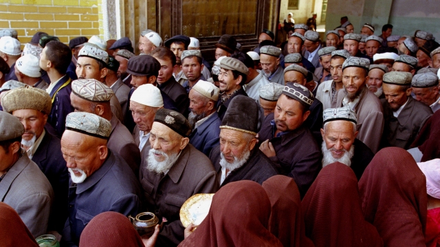 Muslim Uighur men leave after a service at the Idkah Mosque in April, 26 2002 in Kashgar, Xinjiang Region, China