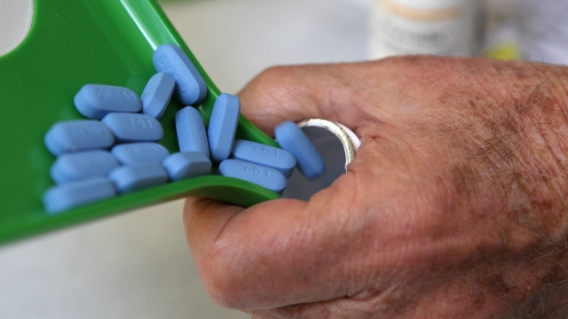 A pharmacist pours Truvada pills back into the bottle
