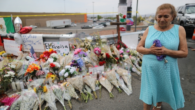 Woman walks past memorial in honor of those killed in a shooting at a Walmart in El Paso