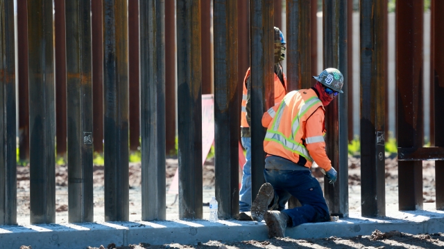 Construction workers build a secondary border wall on February 22, 2019 in Otay Mesa, California