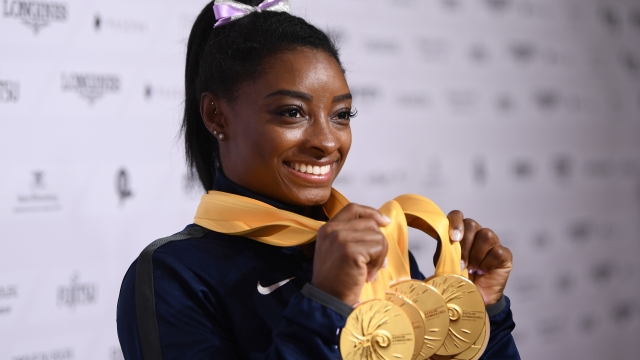 Simone Biles poses with gold medals