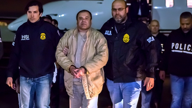"El Chapo" is handcuffed and escorted by ICE officers