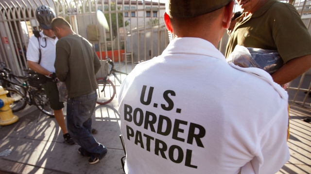 U.S. Border Patrol agents speaking with immigrants
