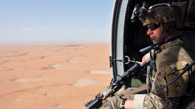 U.S. soldier flies in helicopter over Afghanistan
