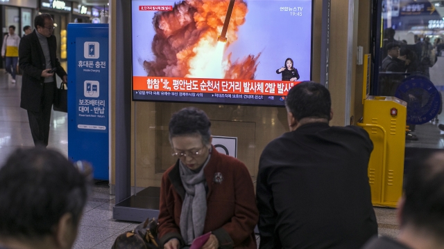 People watch a television broadcast reporting the North Korean missile launch at the Seoul Railway Station on October 31