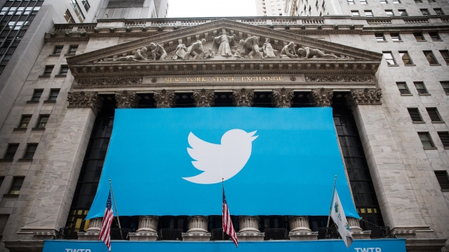 A flag with Twitter's logo hangs outside of the New York Stock Exchange