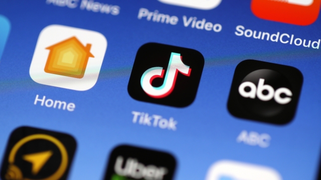 The Tik Tok app is displayed on an iPhone