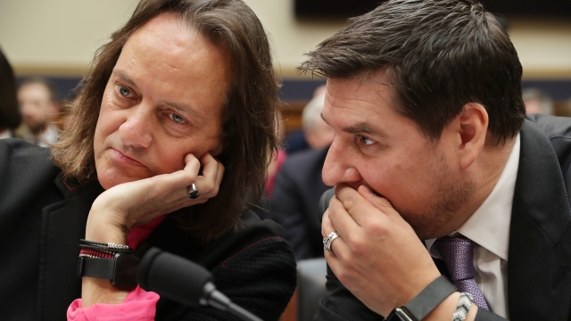 T-Mobile CEO John Legere and Executive Director of Sprint Marcelo Claure chat at a House Judiciary Committee hearing