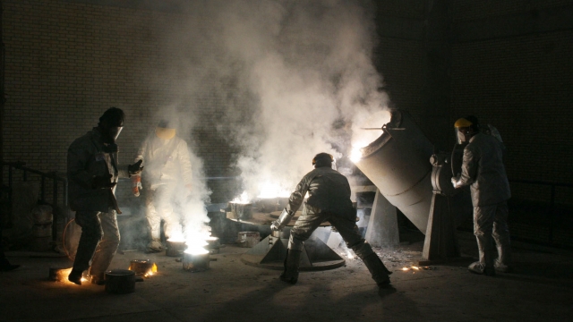 Men work inside of an uranium conversion facility March 30, 2005 just outside the city of Isfahan, Iran