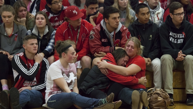 Members of the community and students grieve during a gathering at Marysville-Pilchuck High School on October 26, 2014