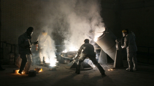 Technicians work inside of a uranium conversion facility producing unit