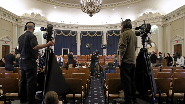 Journalists and camera crews report from inside the impeachement hearing room