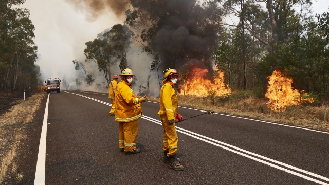 Fire crews work to control bush fires with back burns