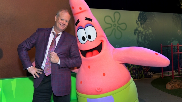 Actor Bill Fagerbakke poses with his character, Patrick Star