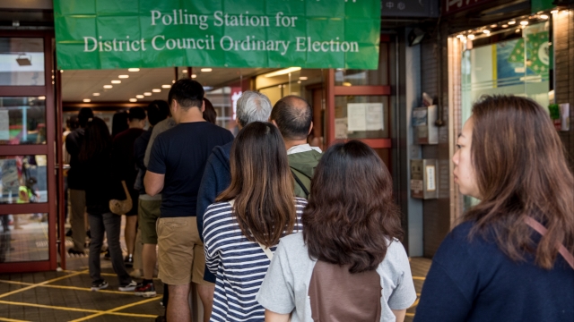 People line up at a polling station to vote in the Hong Kong District Council elections on November 24, 2019