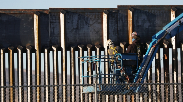People working on the U.S./ Mexico border wall