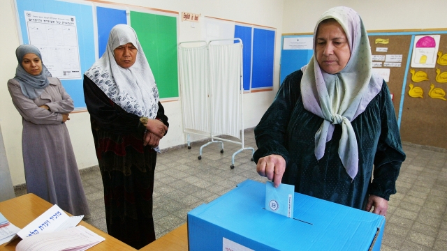 A woman turns in her ballot during an Israeli general election