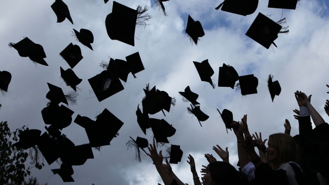Mortarboards are thrown in the air during graduation