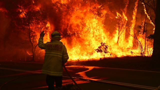 A firefighter battles a blaze in New South Wales, Australia