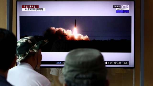 People watch a TV showing a file image of a North Korea's missile launch at the Seoul Railway Station on August 06, 2019