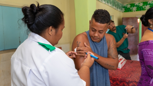A nurse administering the measles vaccine