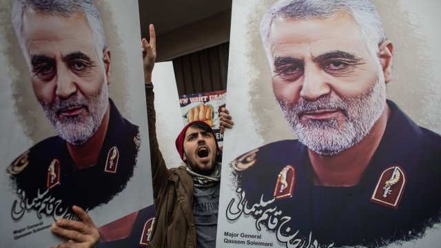 Iranian supporter holds poster portrait of Iranian Revolutionary Guard General Qassem Solemani
