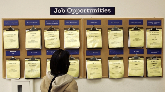 A woman looks at a list of available jobs