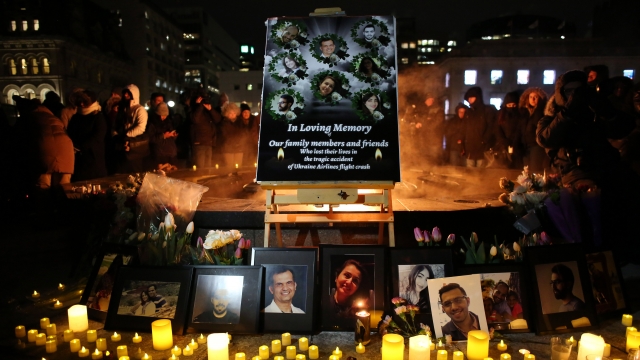 An altar with photographs of the victims who were killed in a plane crash in Iran