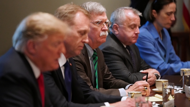Former national security advisor John Bolton participates in a meeting with President Donald Trump