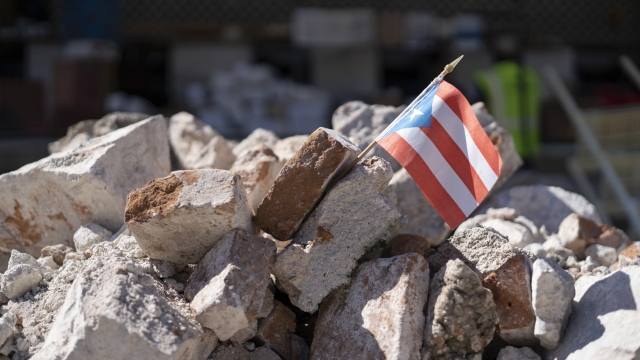 A Puerto Rican flag in a pile of rubble
