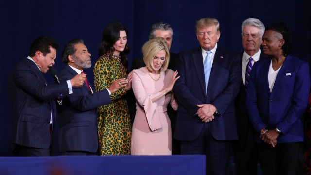 President Trump prays with supporters