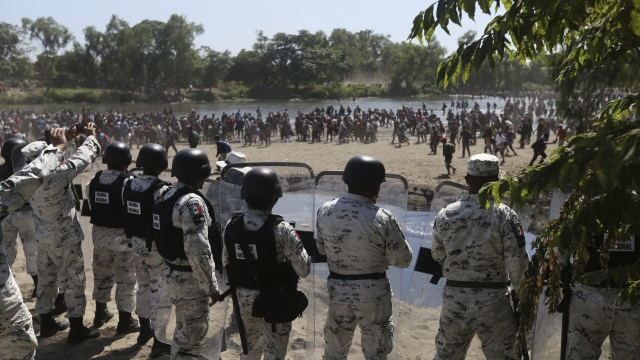 Migrants crossing from Central America are greeted by Mexican National Guard troops.