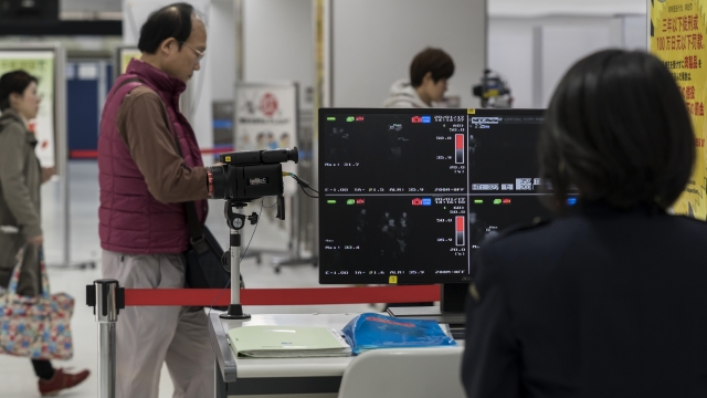 A health worker monitors a thermal scanner as passengers arrive at Narita airport on January 17, 2020 in Narita, Japan.