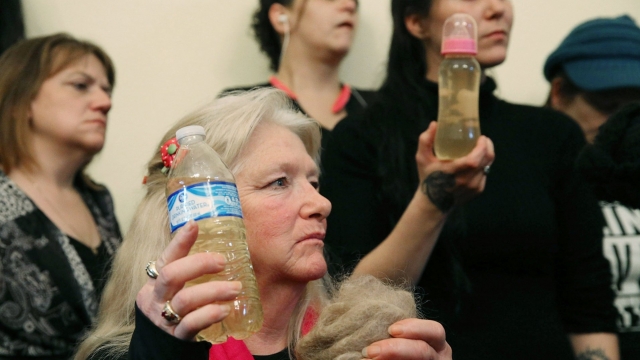 Flint residents hold bottles full of contaminated water