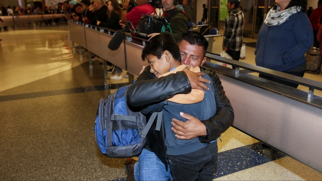 David Xol-Cholom hugs his son Byron at Los Angeles International Airport as they reunite after being separated
