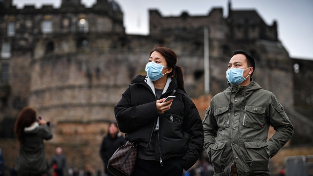 Tourists wearing medical face masks