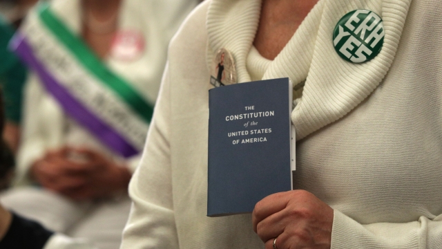 An ERA activist holds a copy of the U.S. Constitution