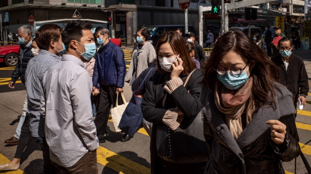 People wear surgical masks in Hong Kong.