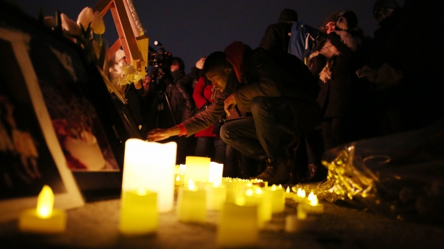 Friends and relatives gather during a candle light vigil.