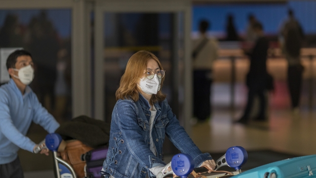 Travelers arrive to LAX wearing medical masks for protection against coronavirus on February 2nd.