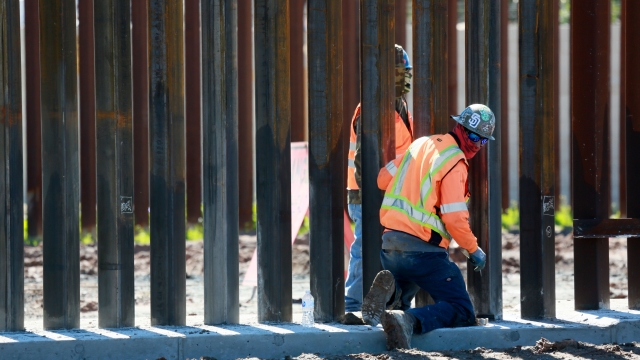Construction workers building a secondary border wall in Otay Mesa, Calif.