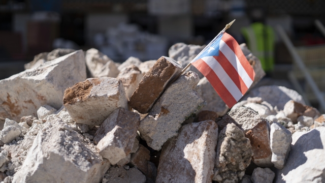 A Puerto Rican flag in a pile of rubble