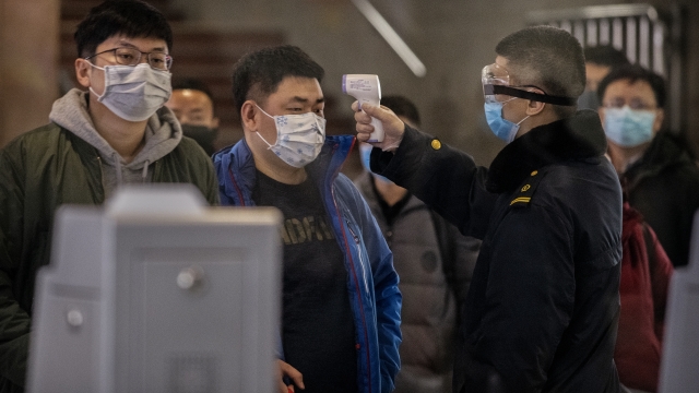 A Chinese man has his temperature checked amid a coronavirus outbreak