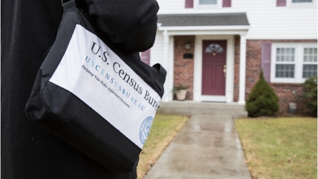A Census Bureau employee walks up to a home