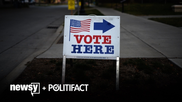 A voting sign sits outside.