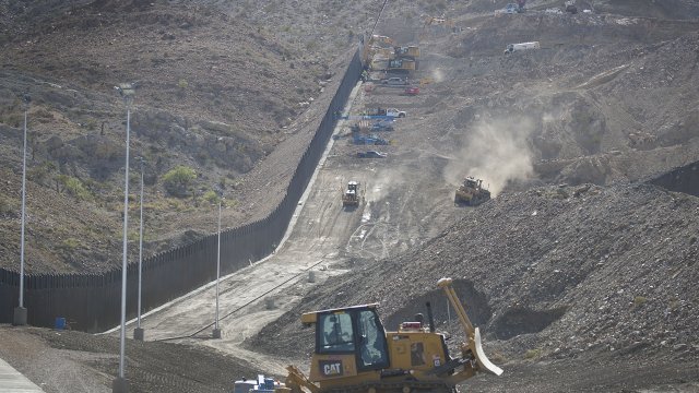 Construction crews work on a border wall in Sunland Park, New Mexico