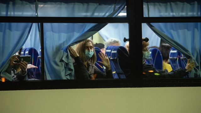 Americans look out from the bus taking them from the quarantined Diamond Prince Cruise Ship in Yokohama, Japan.