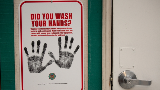 A sign reminding firefighters to wash their hands near a dormitory unit to be used for quarantine of travelers