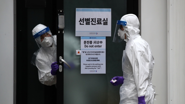 Workers in protective suits disinfect parts of South Korea