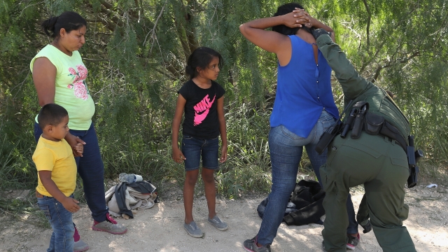Border Patrol agent detains asylum seekers with children in 2018 near McAllen, Texas.